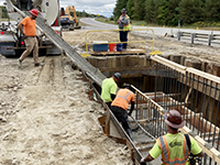 Concrete is poured into in-ground footing base